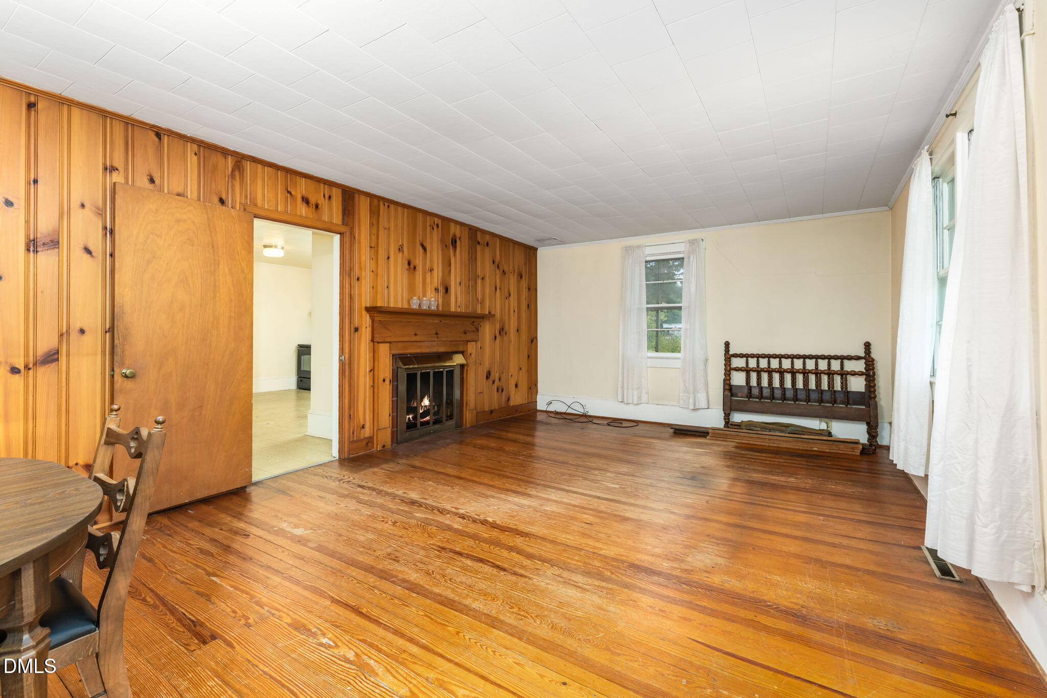 1089 Gillburg Road Henderson, NC 27537 - Photo 6 of 32 a view of a livingroom with wooden floor and a fireplace