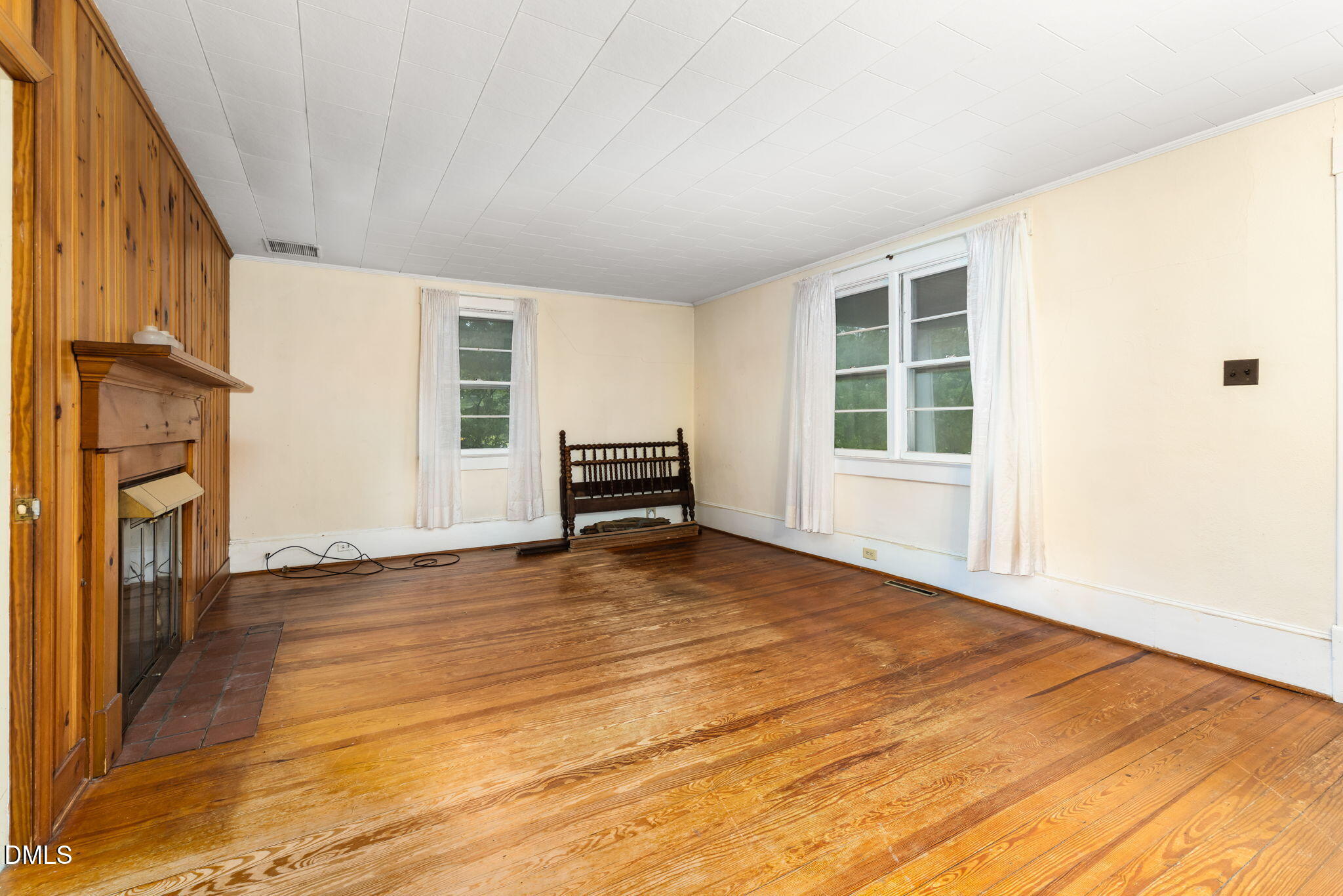 1089 Gillburg Road Henderson, NC 27537 - Photo 7 of 32 a view of empty room with a fireplace and wooden floor