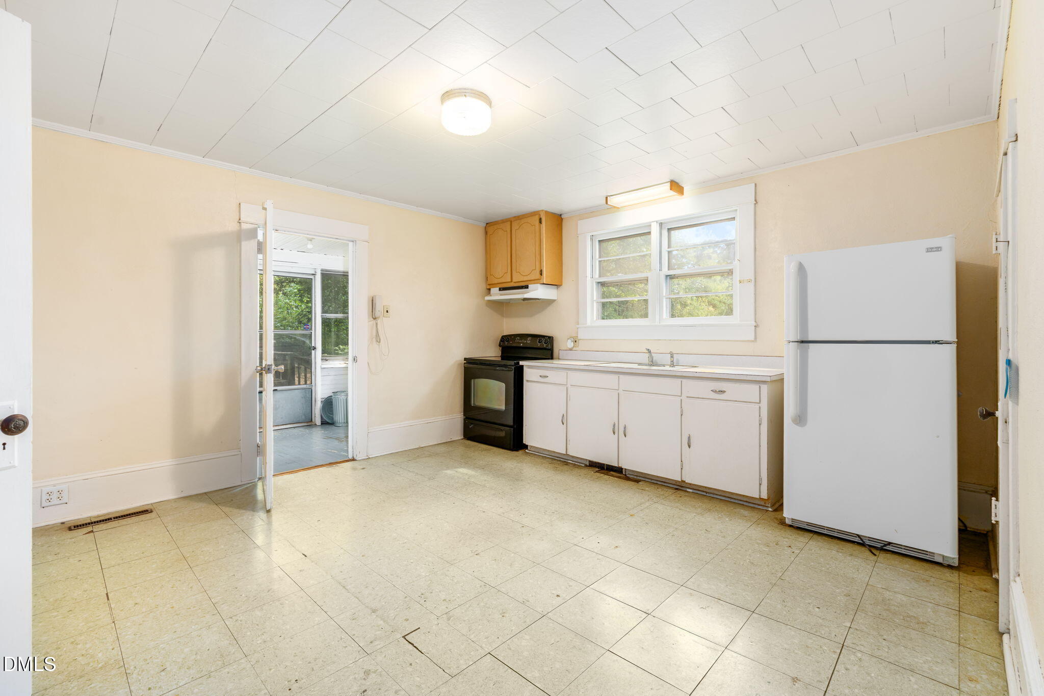 1089 Gillburg Road Henderson, NC 27537 - Photo 9 of 32 a view of a kitchen with a sink dishwasher and a refrigerator