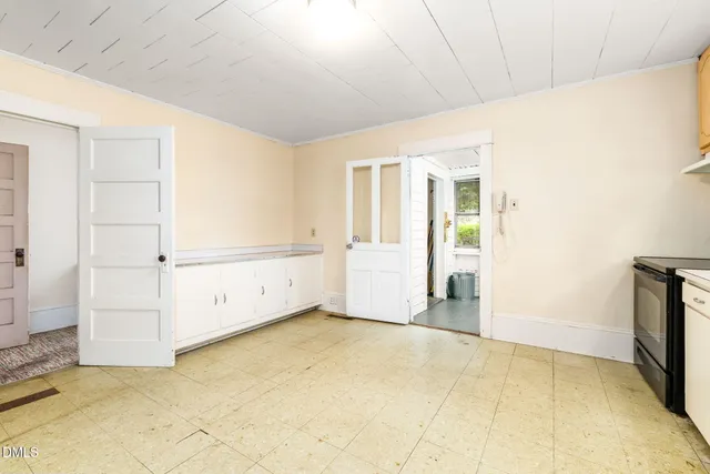 a view of a livingroom with wooden floor and a fireplace
