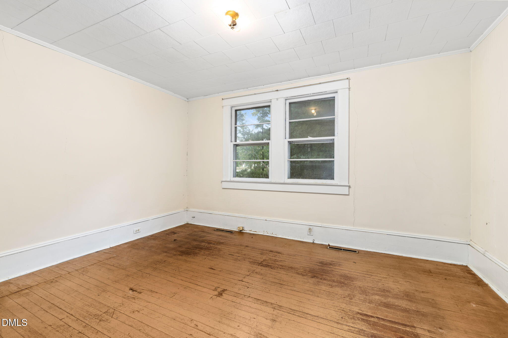 1089 Gillburg Road Henderson, NC 27537 - Photo 18 of 32 an empty room with wooden floor and windows