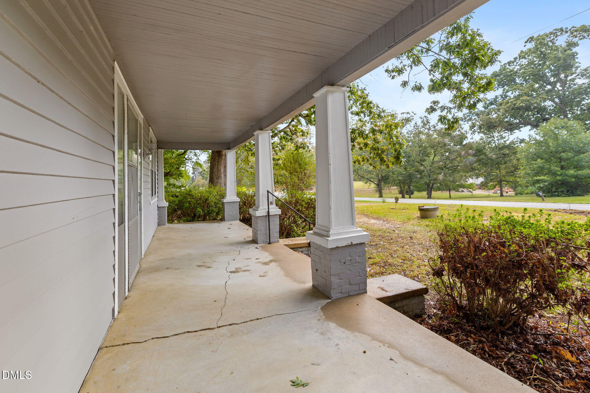 1089 Gillburg Road Henderson, NC 27537 - Photo 26 of 32 a view of a patio with couches plants and large trees