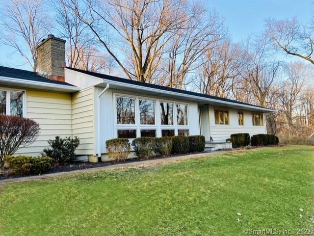 a front view of house with yard and green space