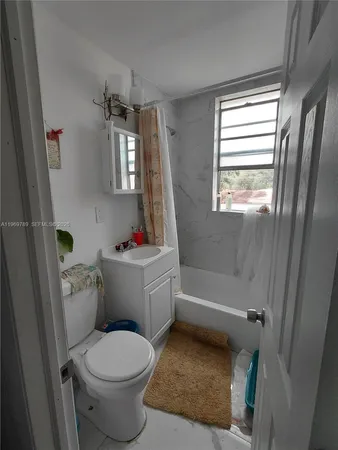 a bathroom with a toilet sink and bathtub