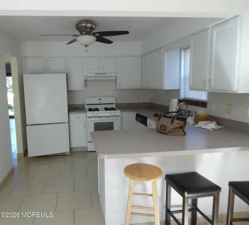 a kitchen with a stove and white cabinets
