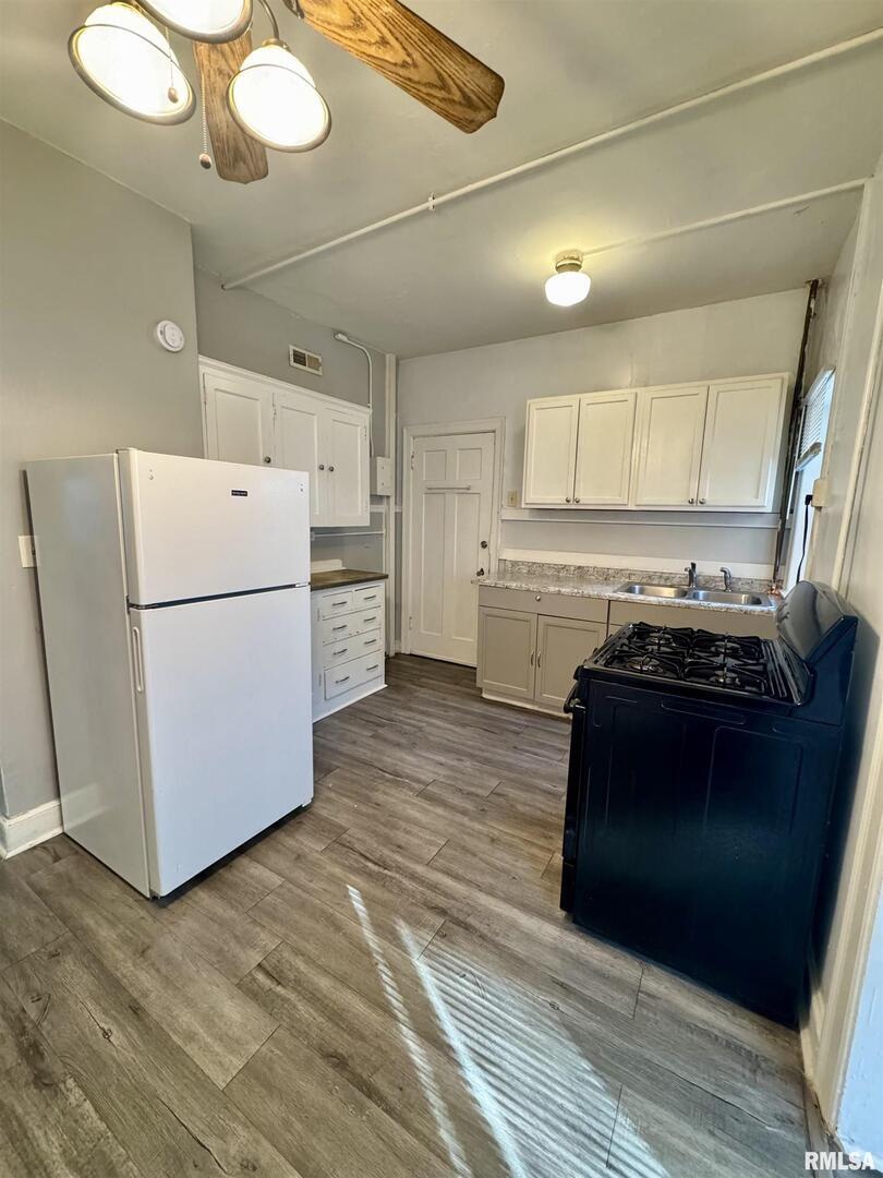 2028 7th Avenue, Unit D1 Moline, IL 61265 - Photo 2 of 9 a kitchen with a refrigerator and a stove