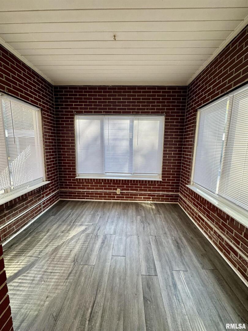 2028 7th Avenue, Unit D1 Moline, IL 61265 - Photo 3 of 9 a view of room with wooden floor and window