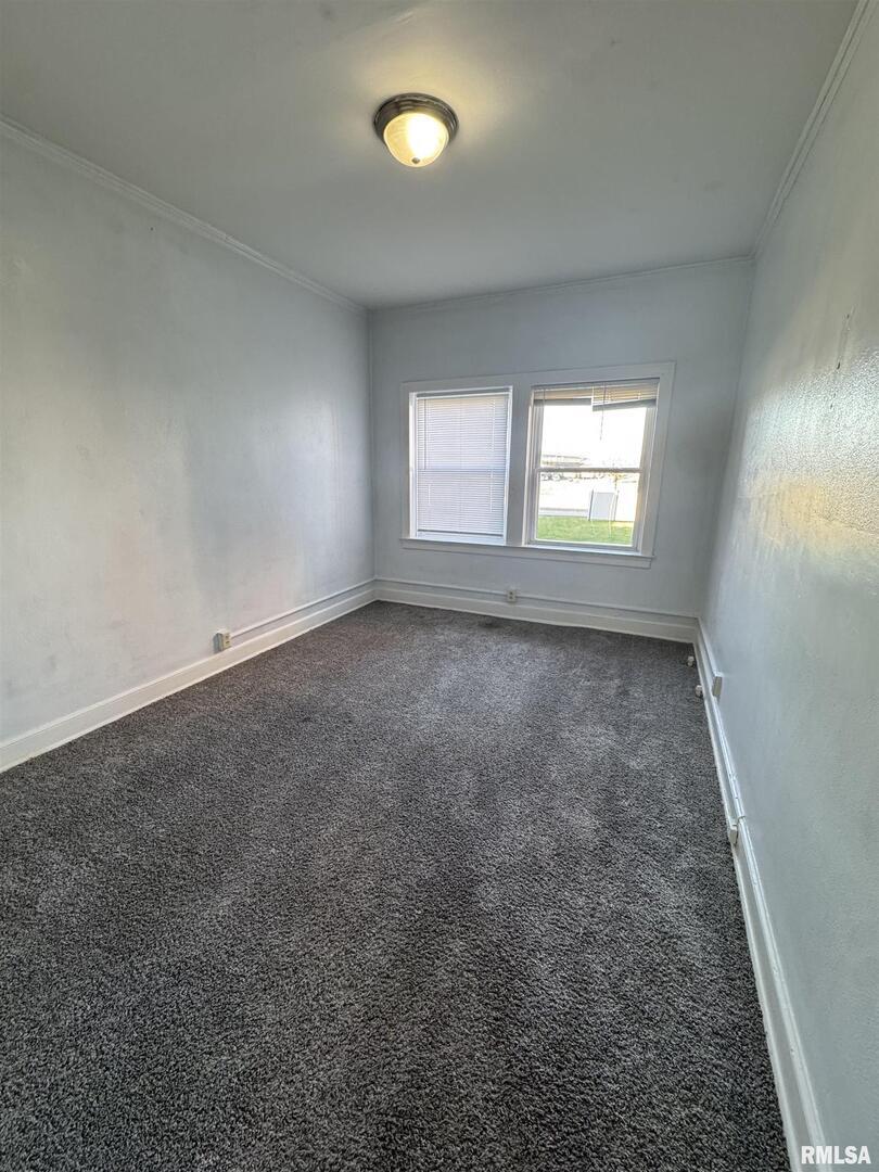 2028 7th Avenue, Unit D1 Moline, IL 61265 - Photo 7 of 9 an empty room with a window and a mirror