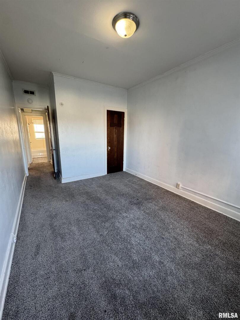 2028 7th Avenue, Unit D1 Moline, IL 61265 - Photo 8 of 9 an empty room with window