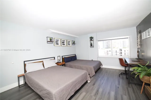 a bedroom with a bed a table and chair