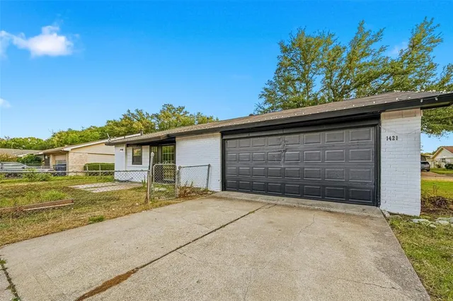 a view of a house with a yard and garage