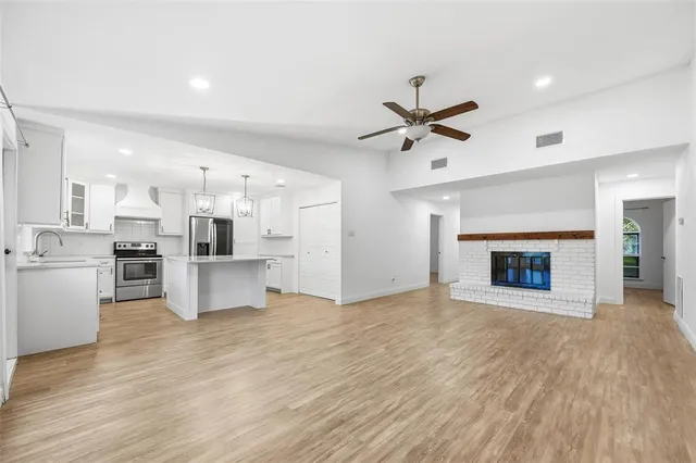 a view of a kitchen with refrigerator and microwave
