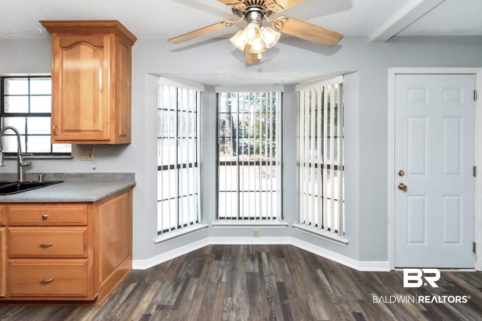 8304 Champlain Circle Mobile, AL 36695 - Photo 18 of 46 Unfurnished dining area with sink, dark hardwood / wood-style floors, and ceiling fan