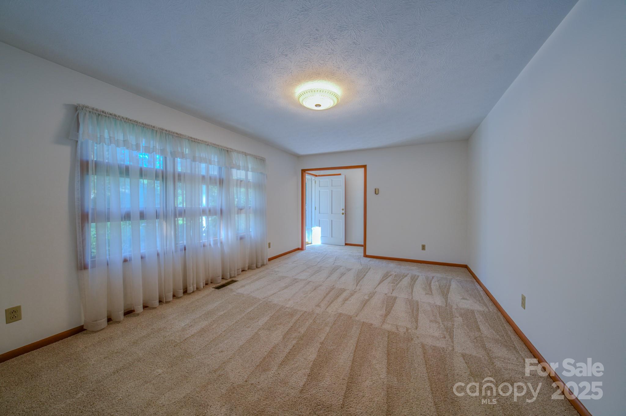 31 Jupiter Road Weaverville, NC 28787 - Photo 11 of 43 an empty room with wooden floor and windows