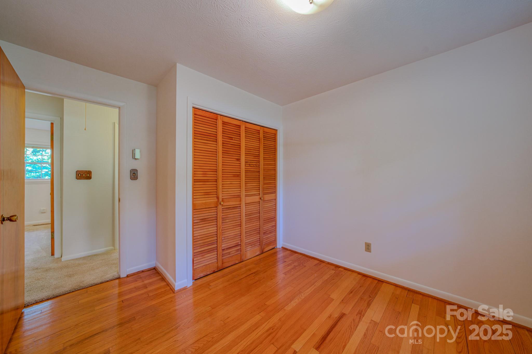 31 Jupiter Road Weaverville, NC 28787 - Photo 12 of 43 an empty room with wooden floor and windows