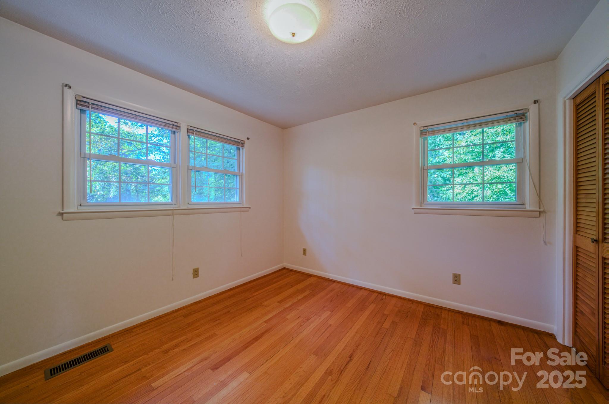 31 Jupiter Road Weaverville, NC 28787 - Photo 14 of 43 a view of a room with wooden floor and windows