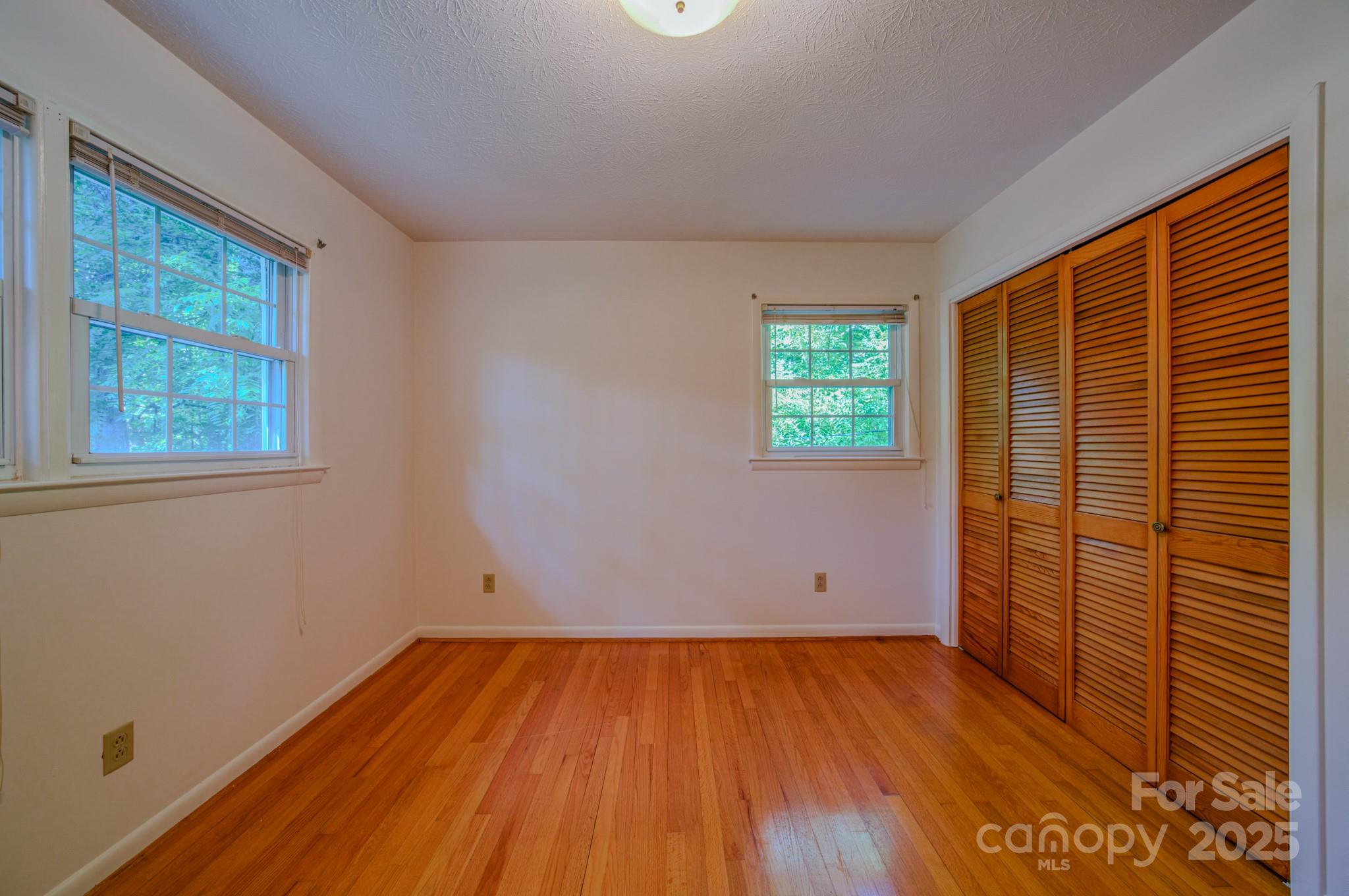31 Jupiter Road Weaverville, NC 28787 - Photo 15 of 43 an empty room with wooden floor and windows
