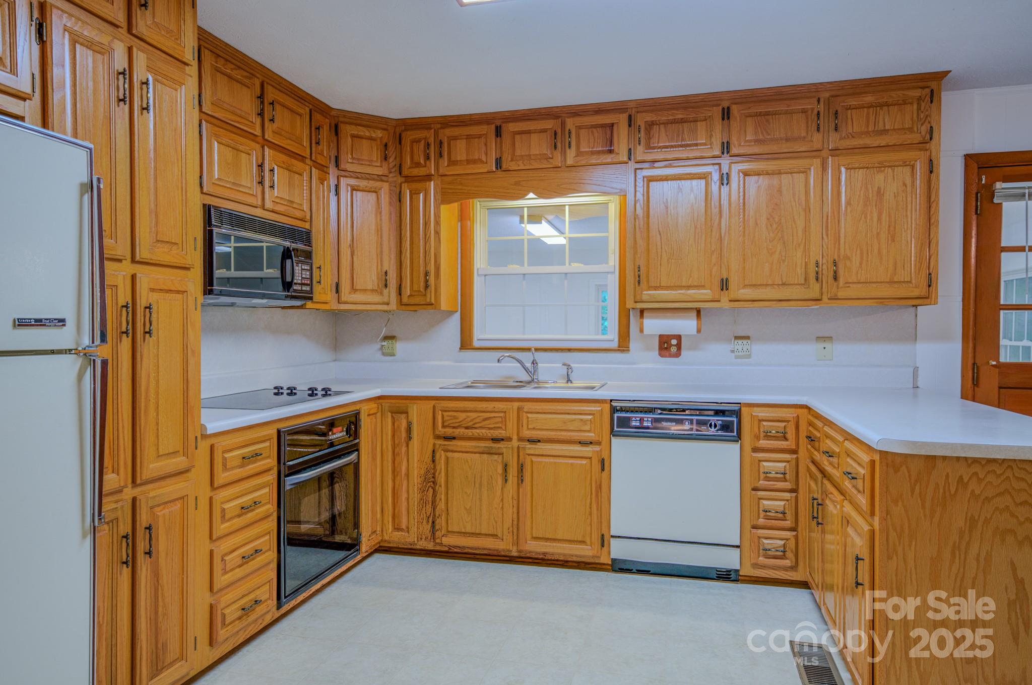 31 Jupiter Road Weaverville, NC 28787 - Photo 2 of 43 a kitchen with stainless steel appliances granite countertop wooden cabinets a stove top oven a sink and dishwasher