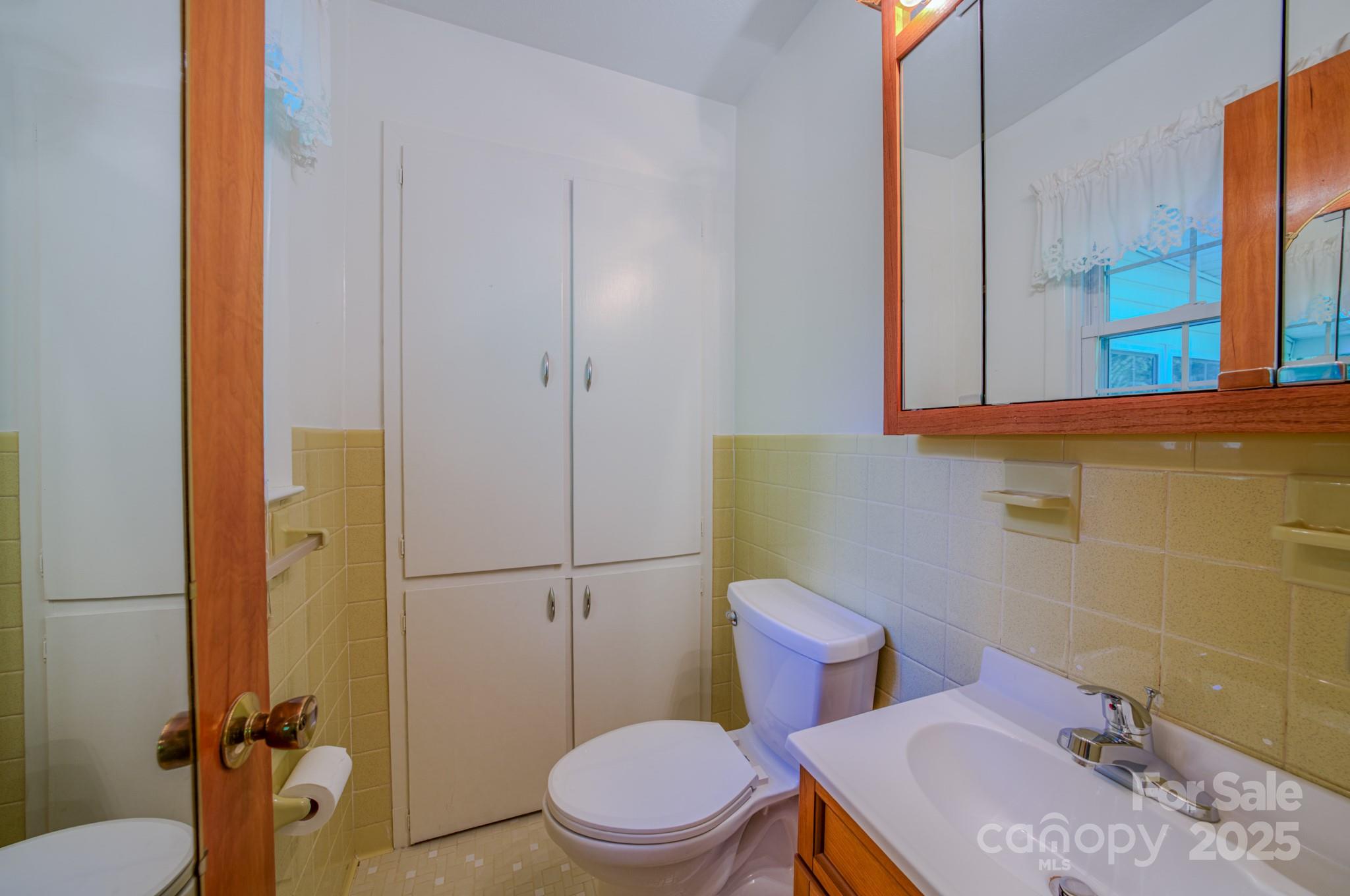 31 Jupiter Road Weaverville, NC 28787 - Photo 22 of 43 a white toilet sitting next to a bathroom sink