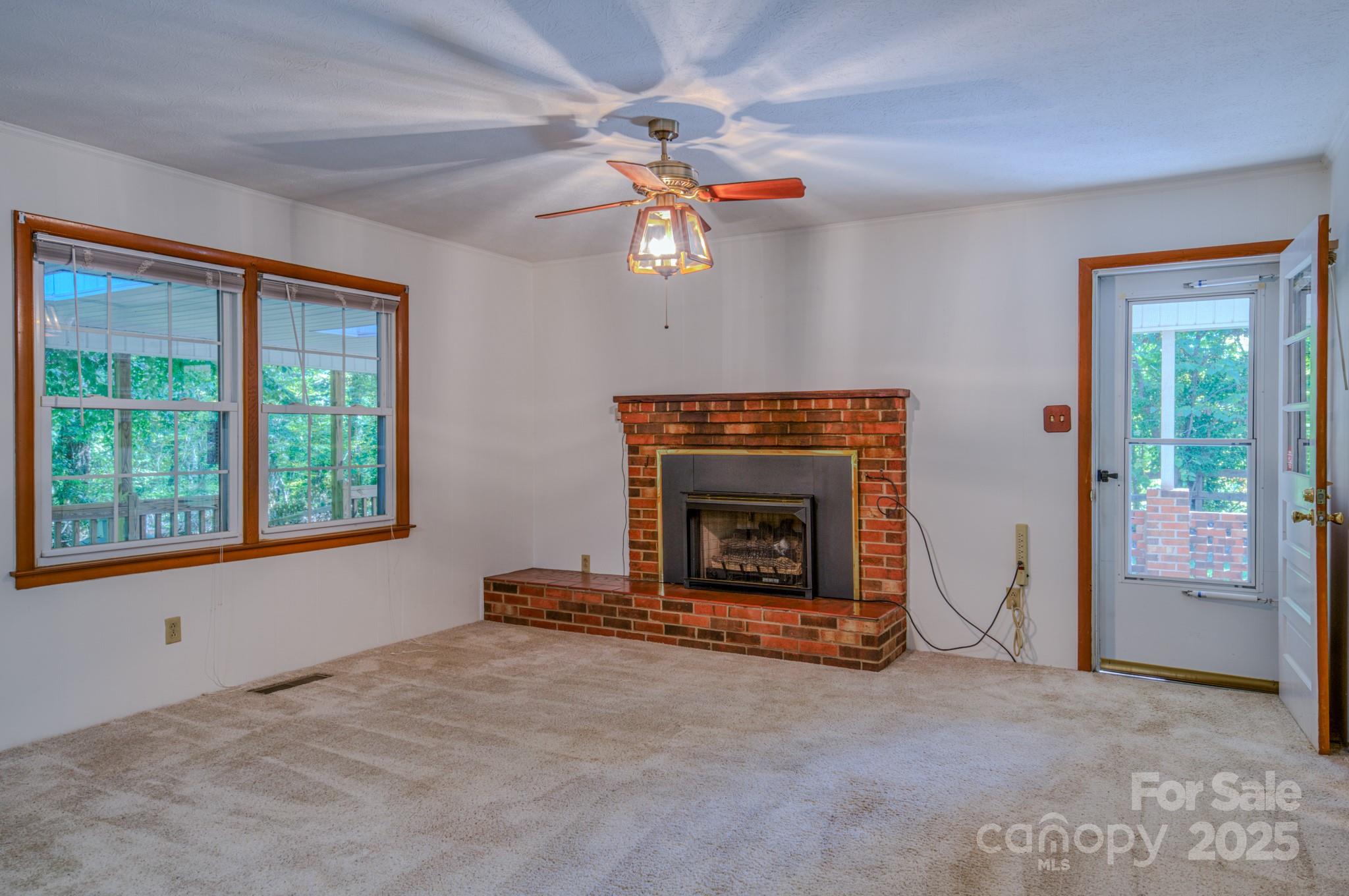 31 Jupiter Road Weaverville, NC 28787 - Photo 3 of 43 wooden floor fireplace and windows in an empty room