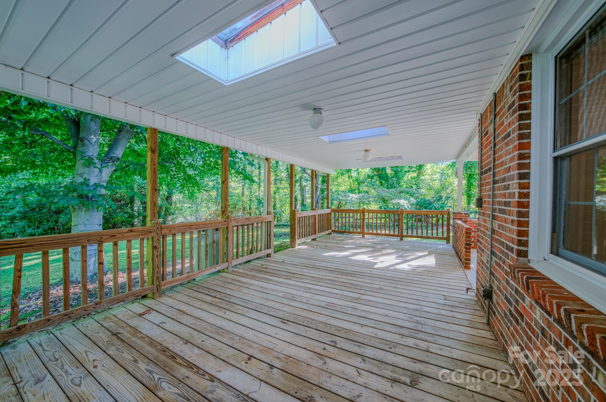 31 Jupiter Road Weaverville, NC 28787 - Photo 31 of 43 a view of porch with wooden floor and floor to ceiling window