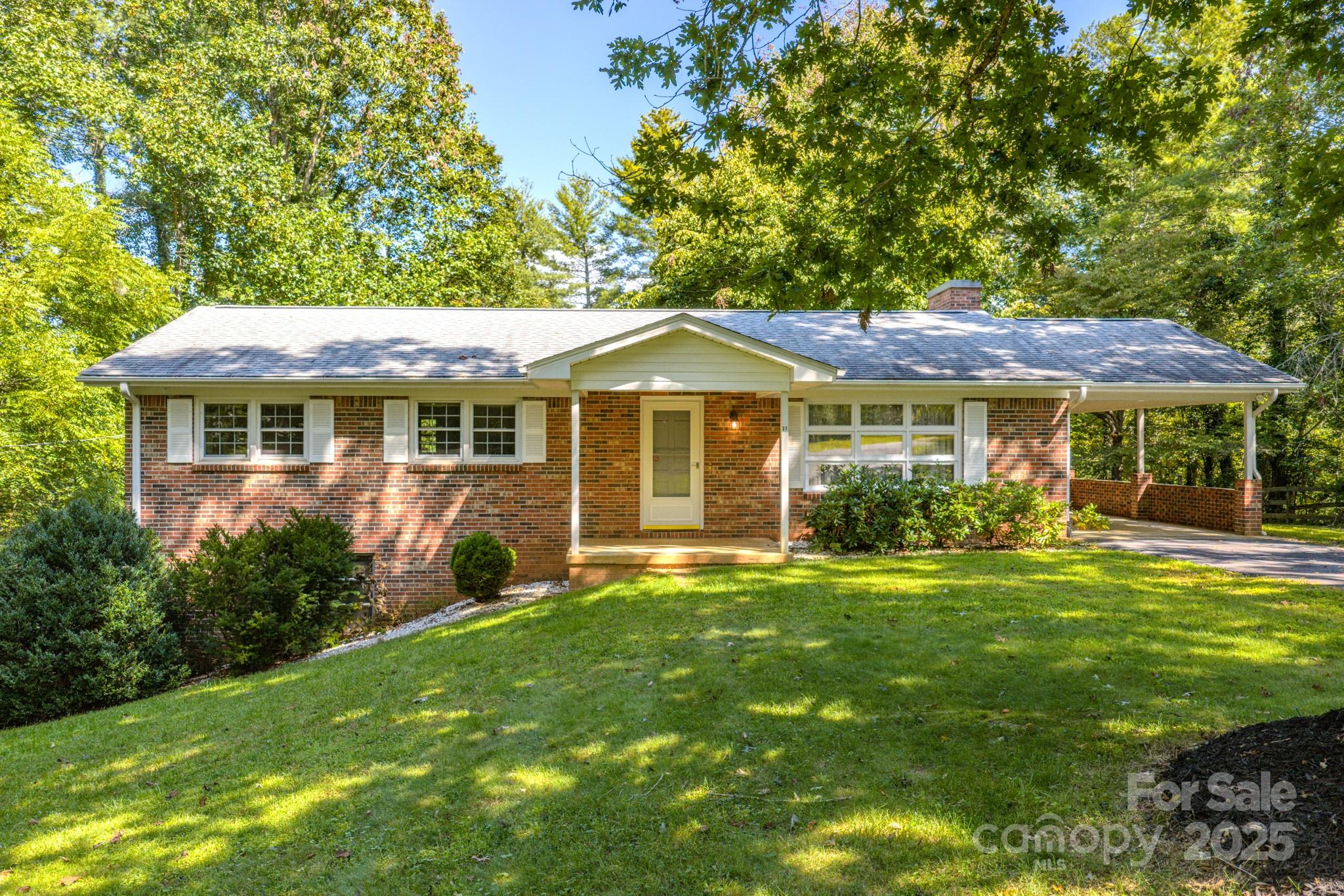 31 Jupiter Road Weaverville, NC 28787 - Photo 39 of 43 a front view of a house with a garden