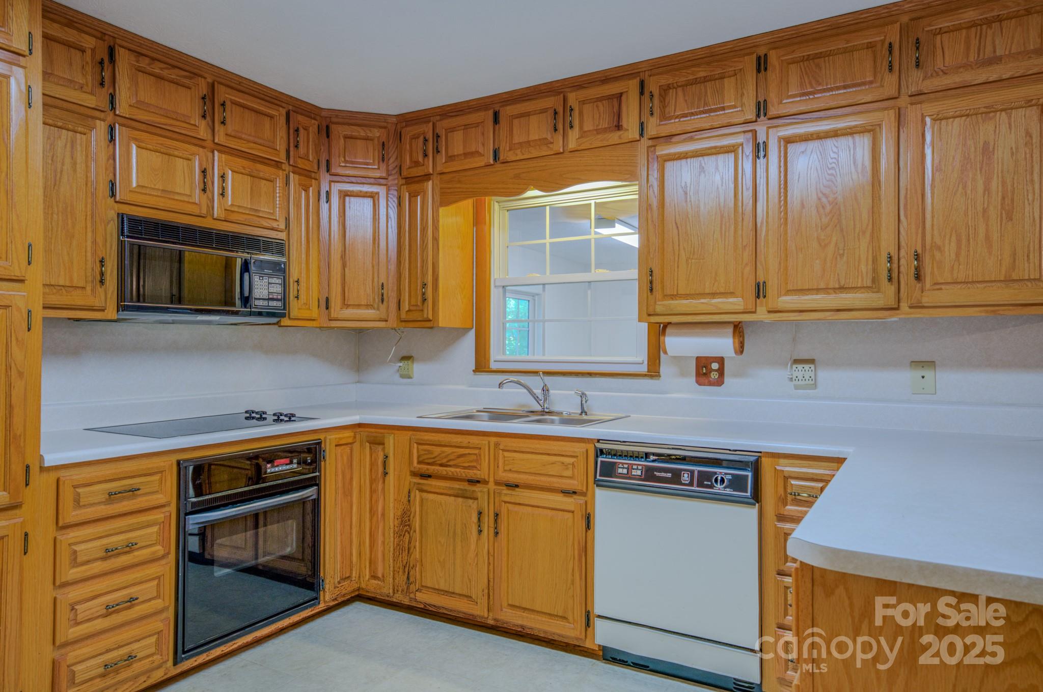 31 Jupiter Road Weaverville, NC 28787 - Photo 4 of 43 a kitchen with stainless steel appliances granite countertop a stove microwave and cabinets
