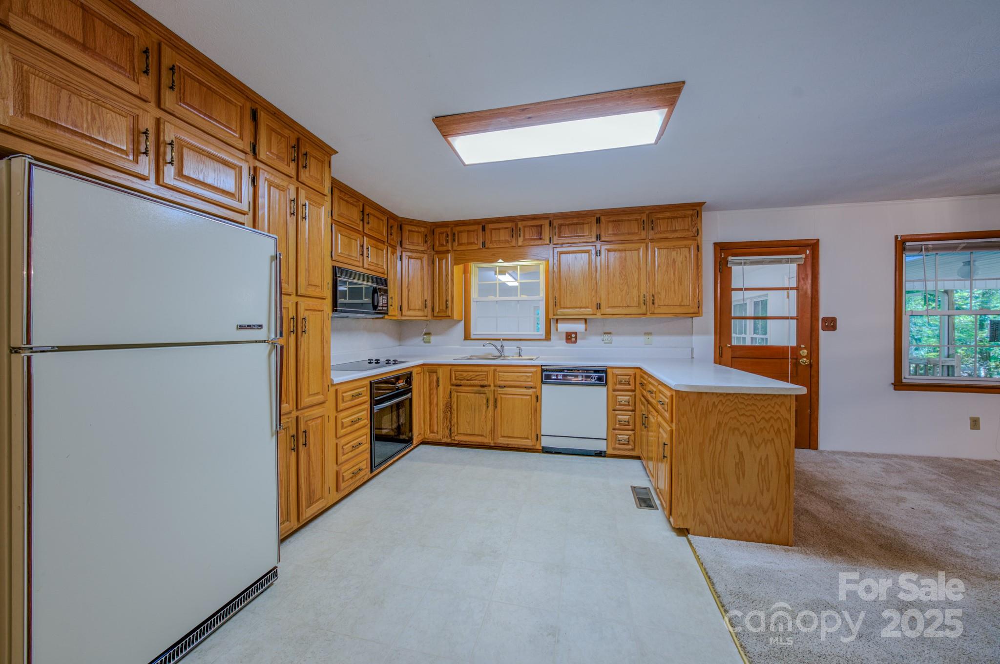 31 Jupiter Road Weaverville, NC 28787 - Photo 5 of 43 a kitchen with stainless steel appliances granite countertop a refrigerator a oven a sink with island and windows