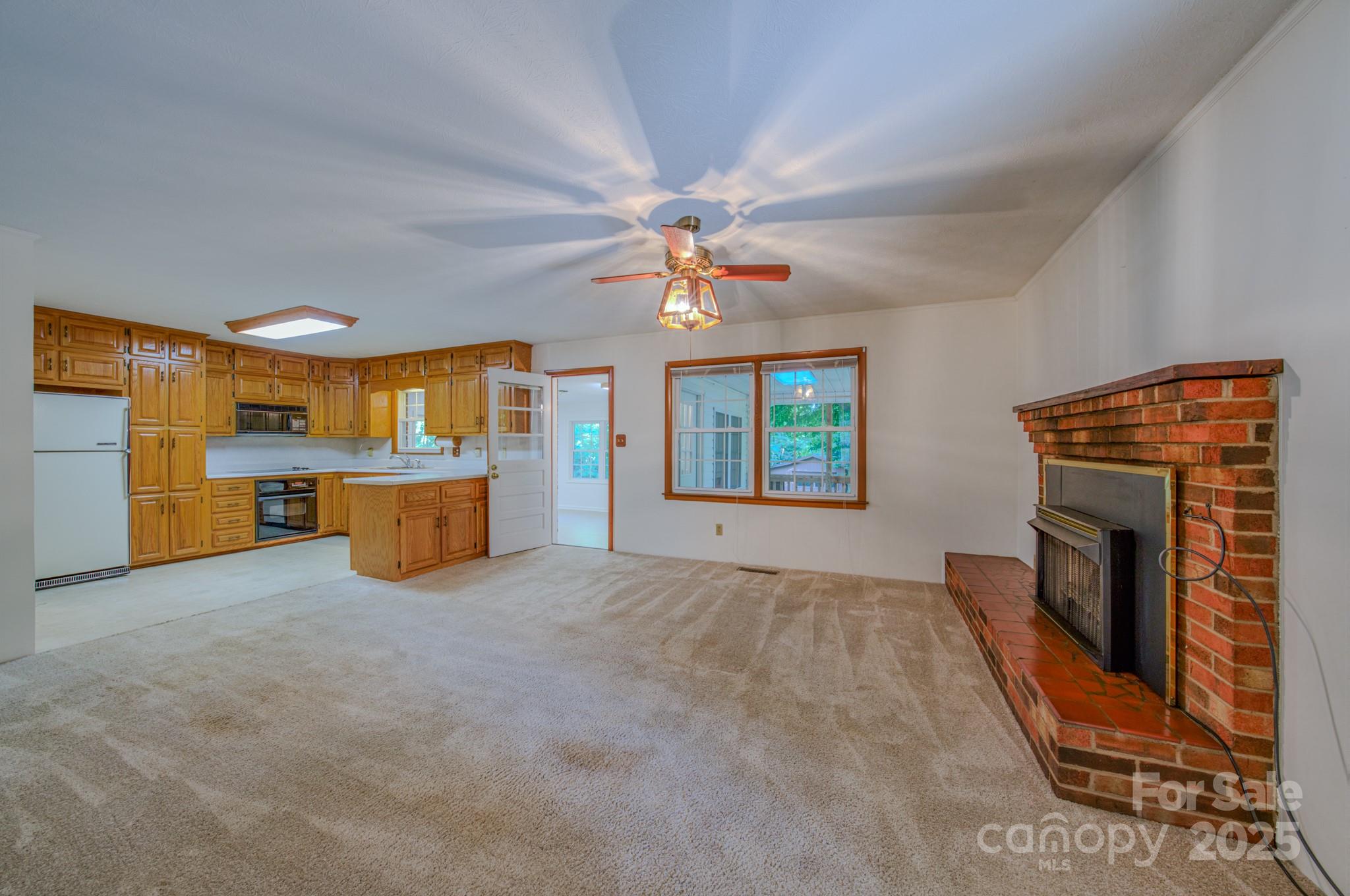 31 Jupiter Road Weaverville, NC 28787 - Photo 7 of 43 wooden floor fireplace and windows in an empty room