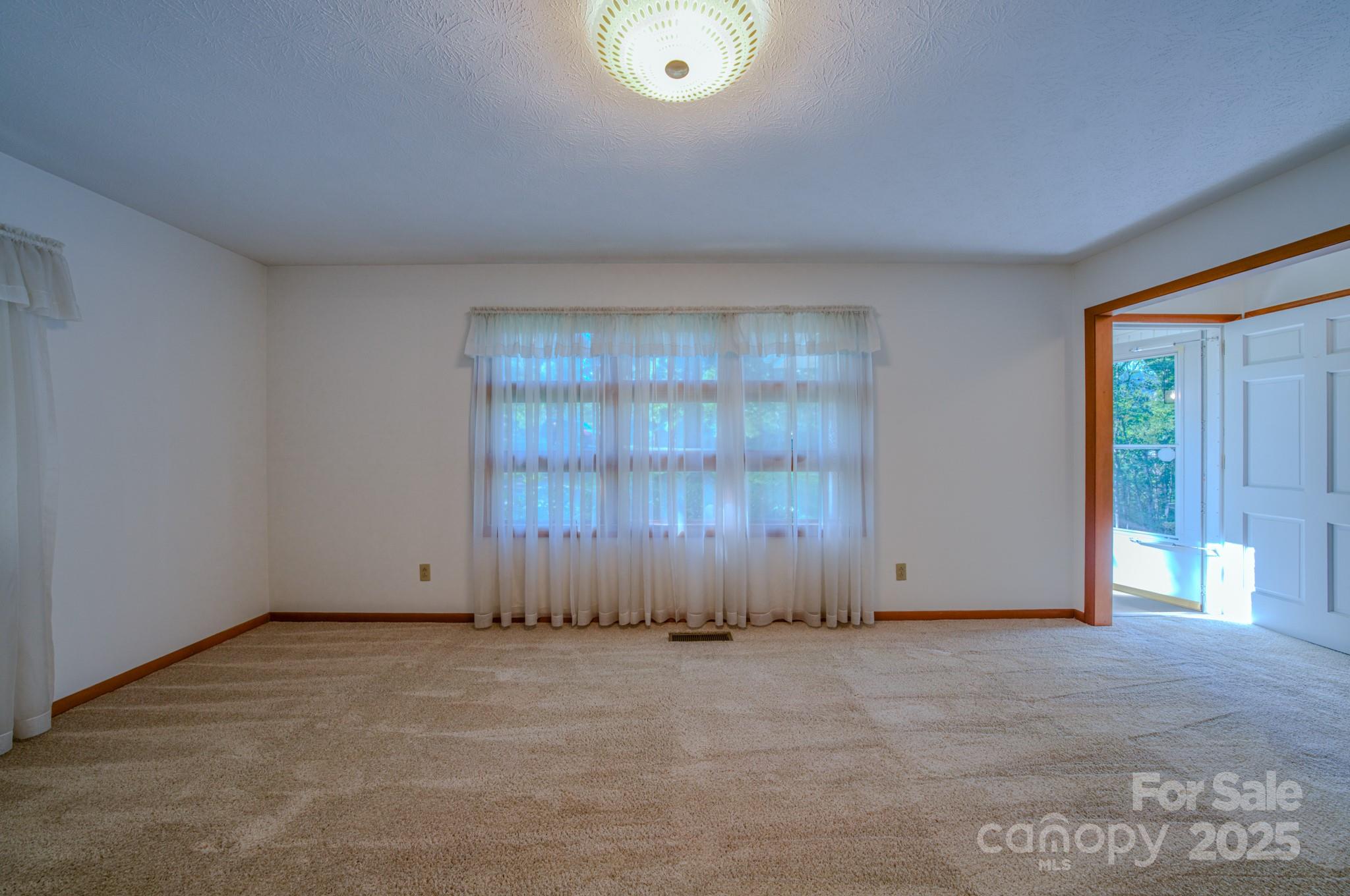 31 Jupiter Road Weaverville, NC 28787 - Photo 10 of 43 an empty room with wooden floor and windows