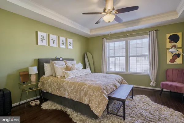 a bedroom with a bed a table and chair