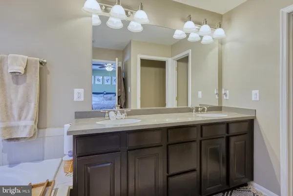 a bathroom with a double vanity sink and a mirror