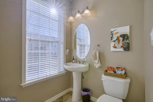 a bathroom with a sink mirror and toilet