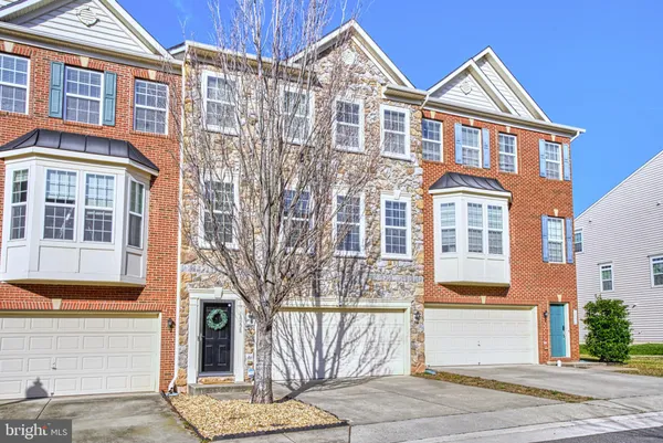a front view of a house with a parking area