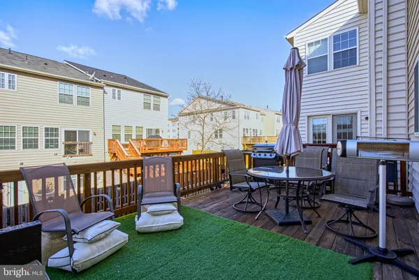 a view of a patio with a dining table and chairs
