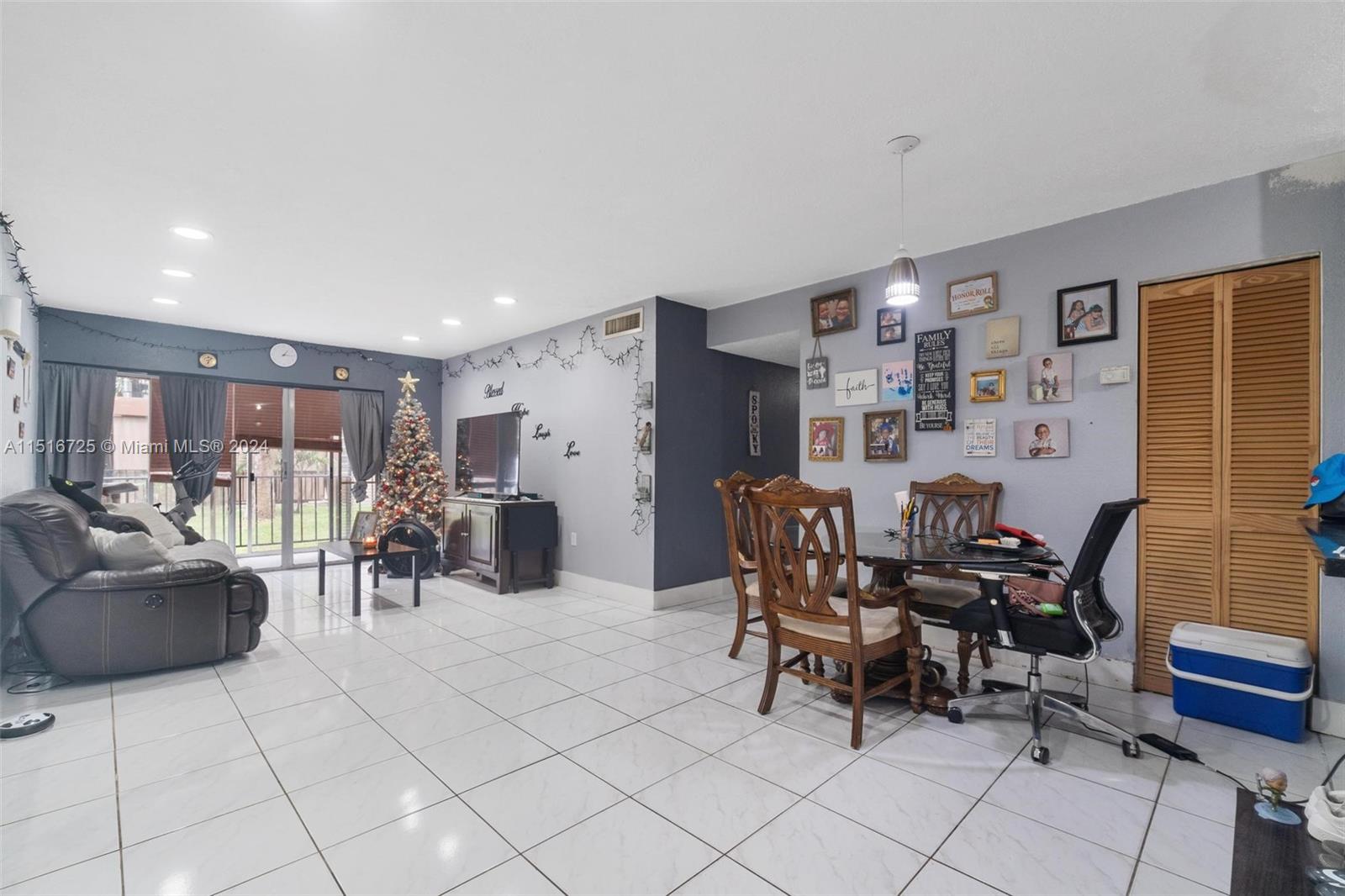 1900 West 68th Street, Unit E104 Hialeah, FL 33014 - Photo 12 of 31 a view of a livingroom with furniture and dining room