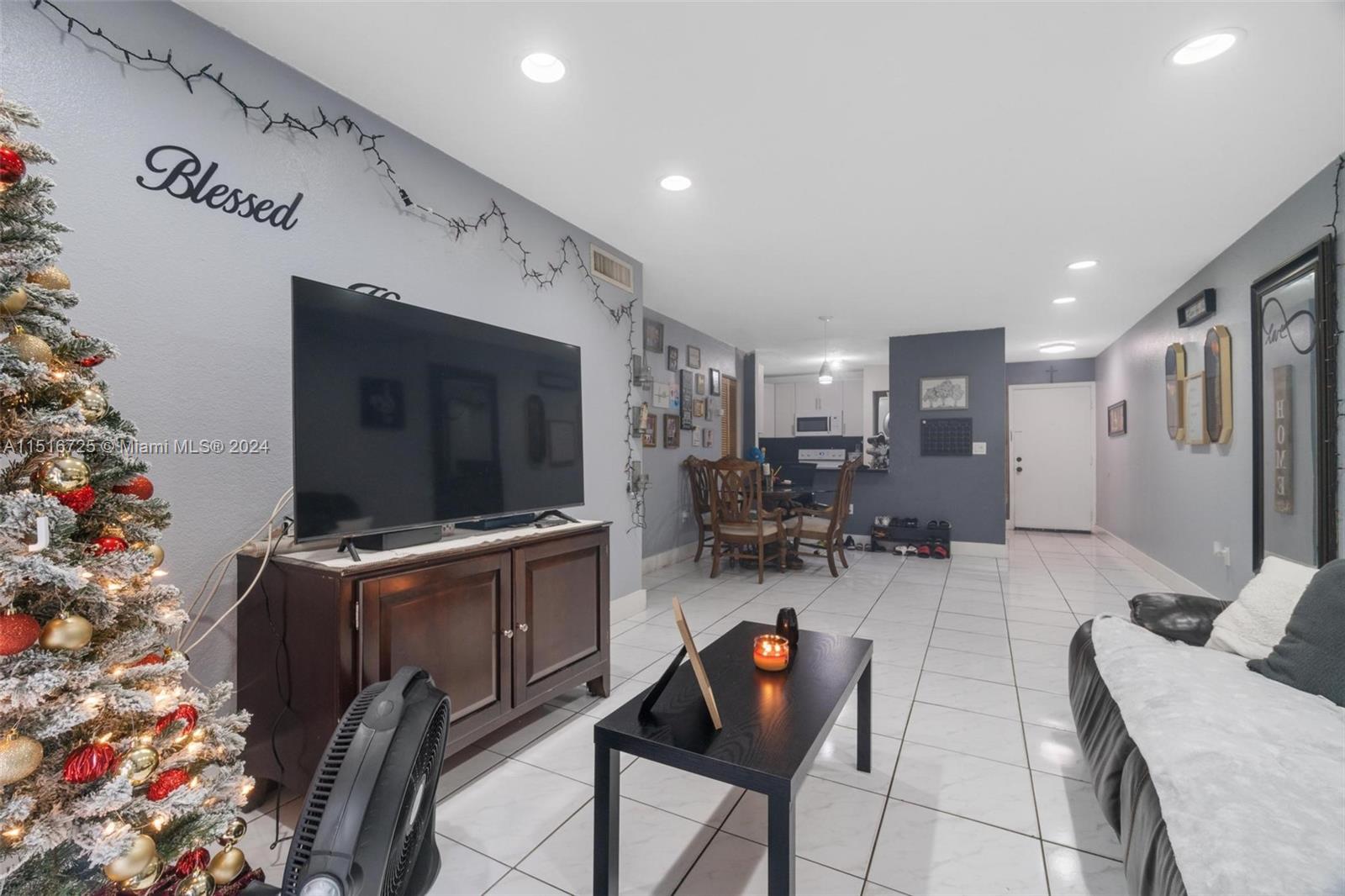 1900 West 68th Street, Unit E104 Hialeah, FL 33014 - Photo 15 of 31 a living room with furniture and a flat screen tv