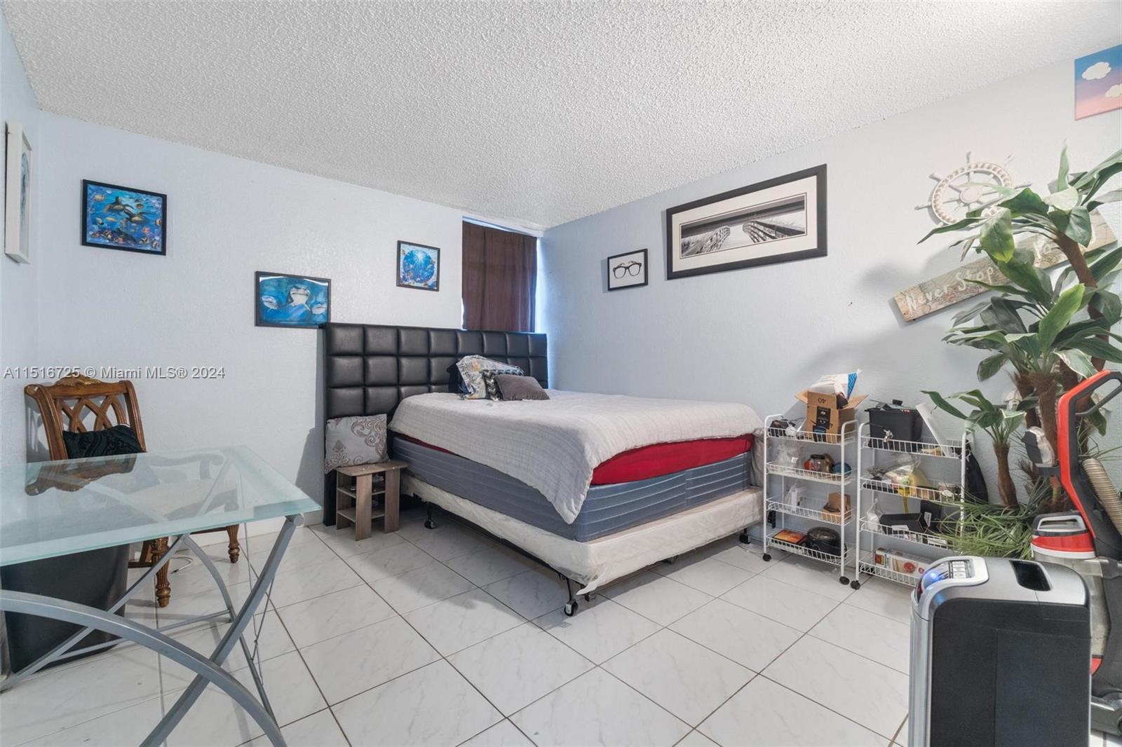 1900 West 68th Street, Unit E104 Hialeah, FL 33014 - Photo 21 of 31 a bedroom with a bed and a desk