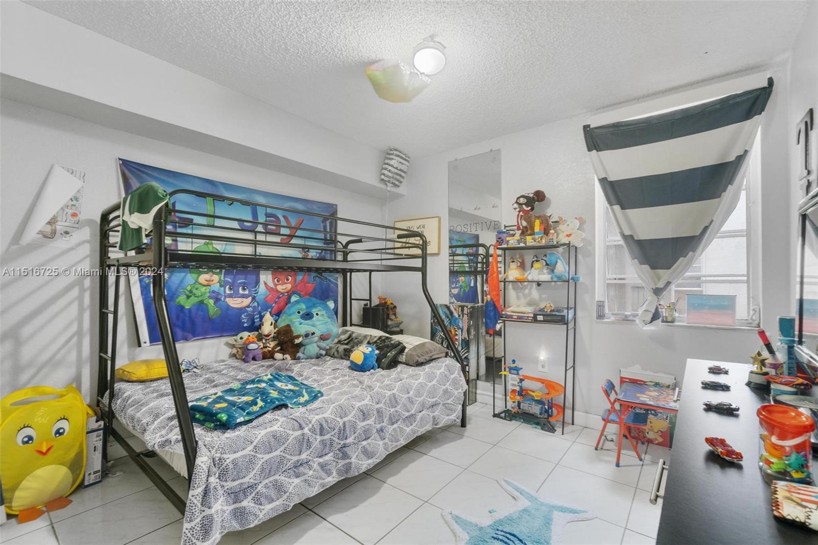 1900 West 68th Street, Unit E104 Hialeah, FL 33014 - Photo 23 of 31 a bedroom with lots of furniture and clutter