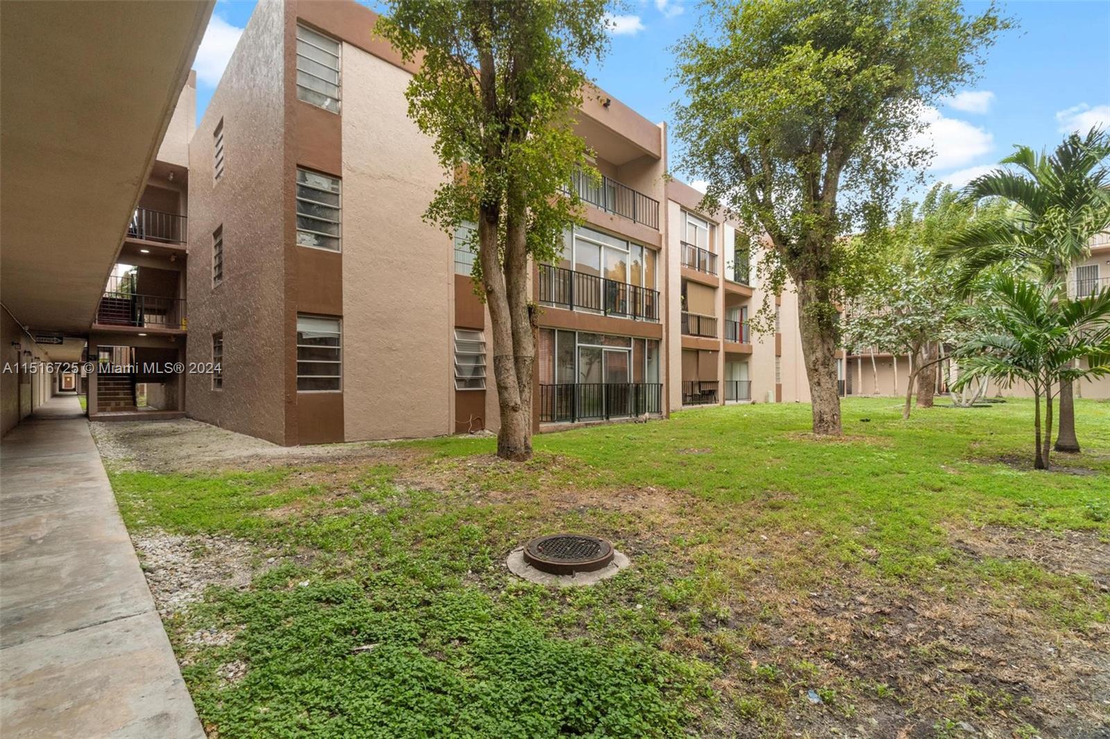 1900 West 68th Street, Unit E104 Hialeah, FL 33014 - Photo 30 of 31 a view of a backyard with large trees