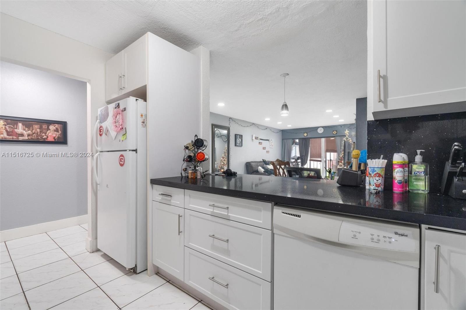 1900 West 68th Street, Unit E104 Hialeah, FL 33014 - Photo 8 of 31 a kitchen with granite countertop cabinets and white appliances