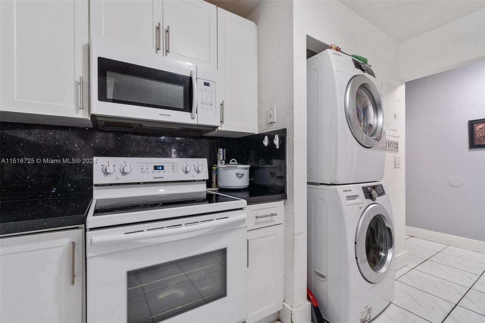 1900 West 68th Street, Unit E104 Hialeah, FL 33014 - Photo 9 of 31 a kitchen with a stove and a microwave