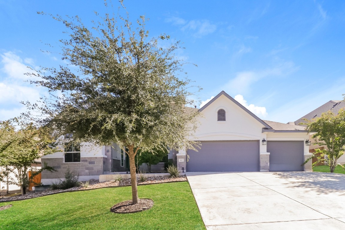 6101 Antelope Well Lane Austin, TX 78738 - Photo 1 of 36 a front view of a house with a yard
