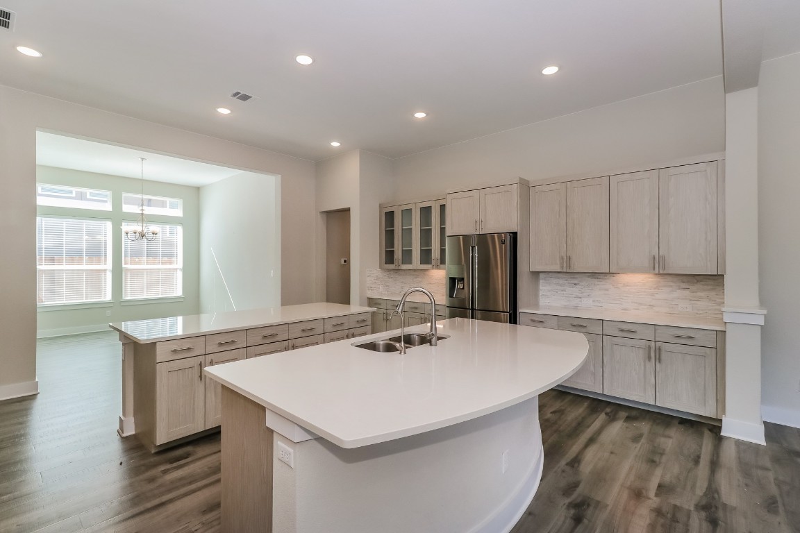 6101 Antelope Well Lane Austin, TX 78738 - Photo 11 of 36 a kitchen with a sink a stove a refrigerator and cabinets