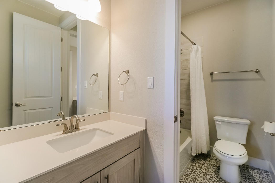 6101 Antelope Well Lane Austin, TX 78738 - Photo 26 of 36 a bathroom with a sink toilet a mirror and shower