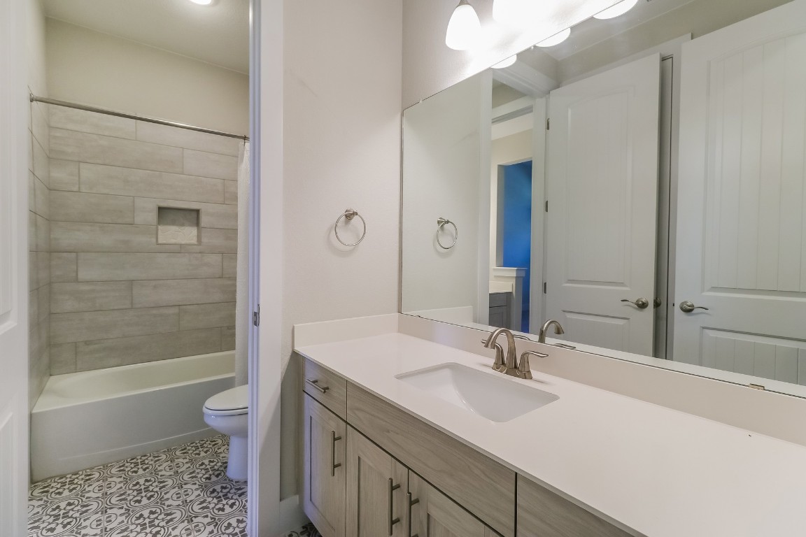 6101 Antelope Well Lane Austin, TX 78738 - Photo 27 of 36 a bathroom with a sink a toilet and shower