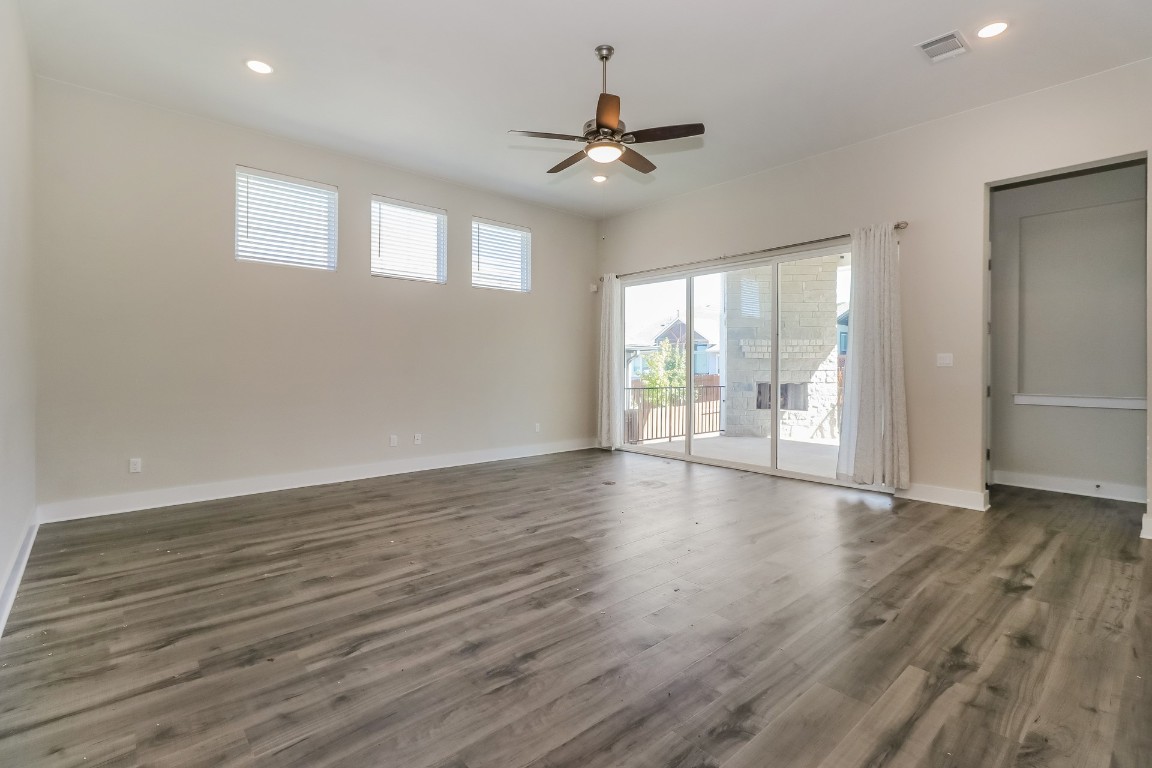 6101 Antelope Well Lane Austin, TX 78738 - Photo 3 of 36 a view of an empty room with wooden floor and a window