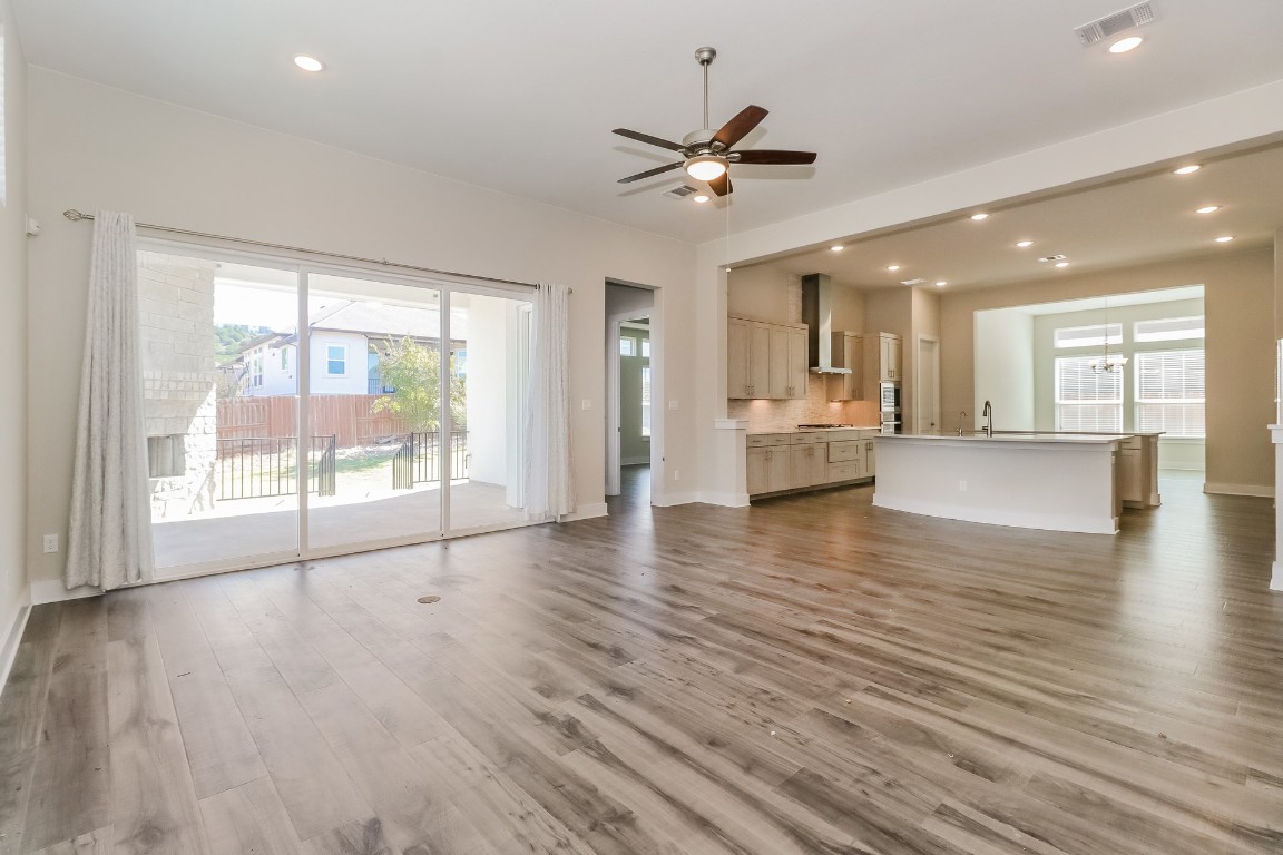 6101 Antelope Well Lane Austin, TX 78738 - Photo 4 of 36 a view of an empty room with wooden floor and a window