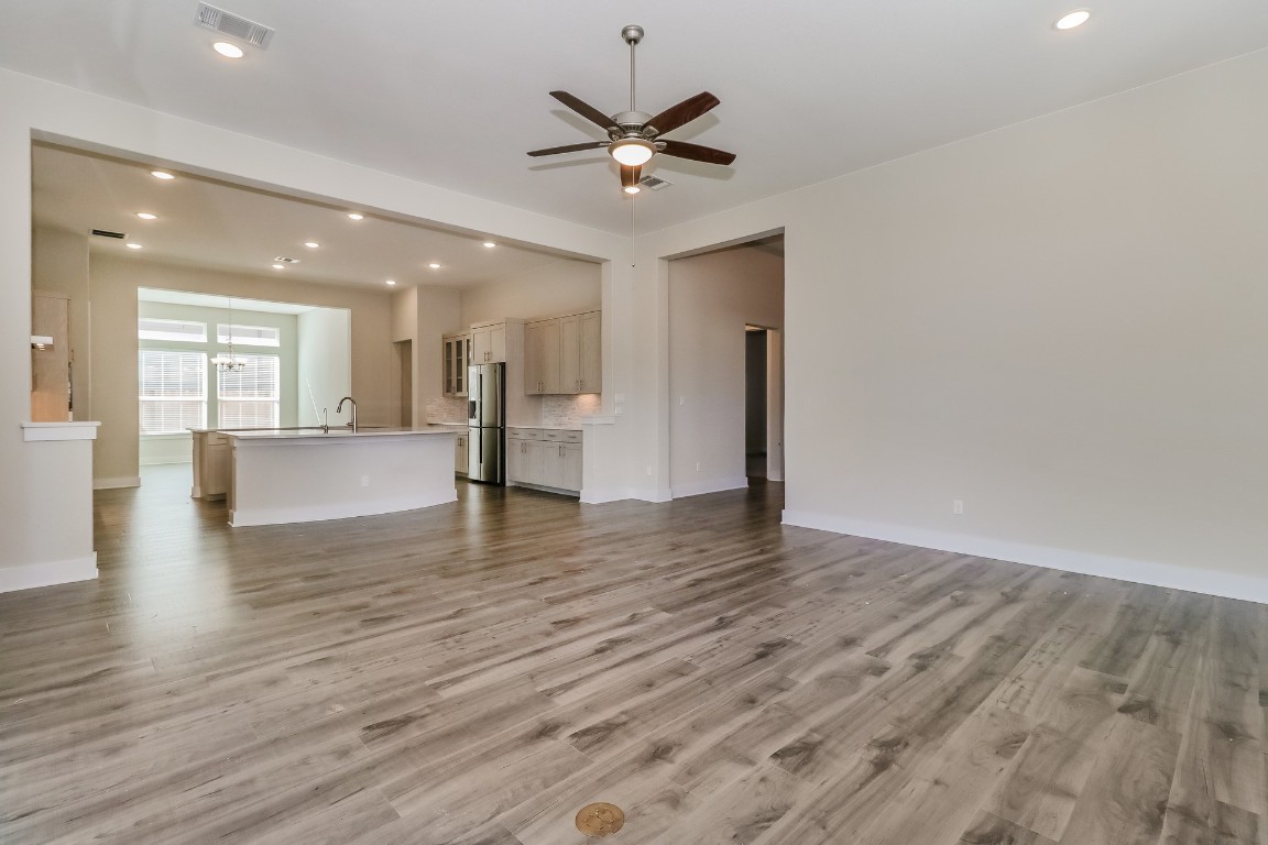 6101 Antelope Well Lane Austin, TX 78738 - Photo 5 of 36 a view of an empty room and wooden floor and a ceiling fan
