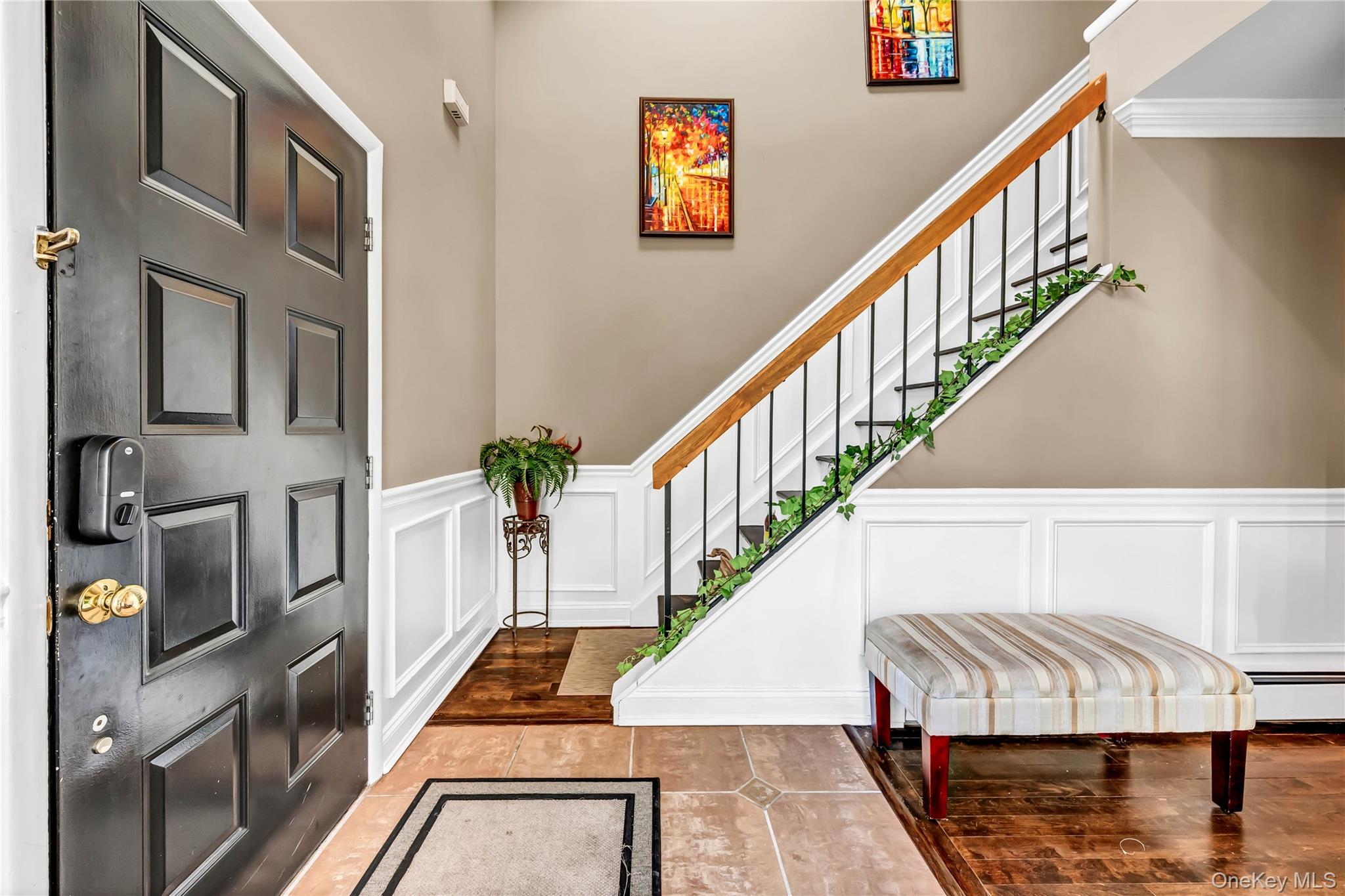 a view of entryway and hall with wooden floor